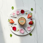 Overhead flat lay with strawberry slices and botanicals